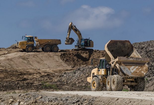 Dump Trucks and Excavator on Construction Side